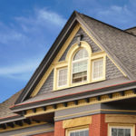 Ornate dormer on house with siding, trim and roof repair.