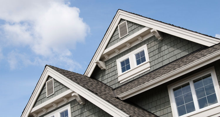Picture of top of home with siding and windows.