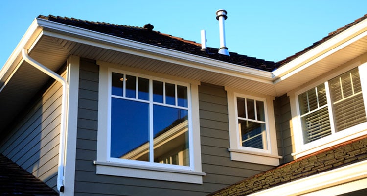 Blue sky with Rochester MI house and new siding and gutters.