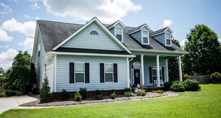 Nice house with light blue siding and windows.