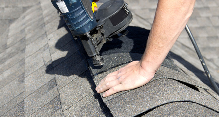 Closeup of Roofing Contractors in Rochester Hills MI Using Nailer