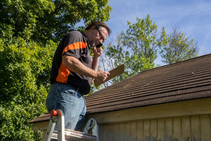 Roof Contractor Looking At Roof