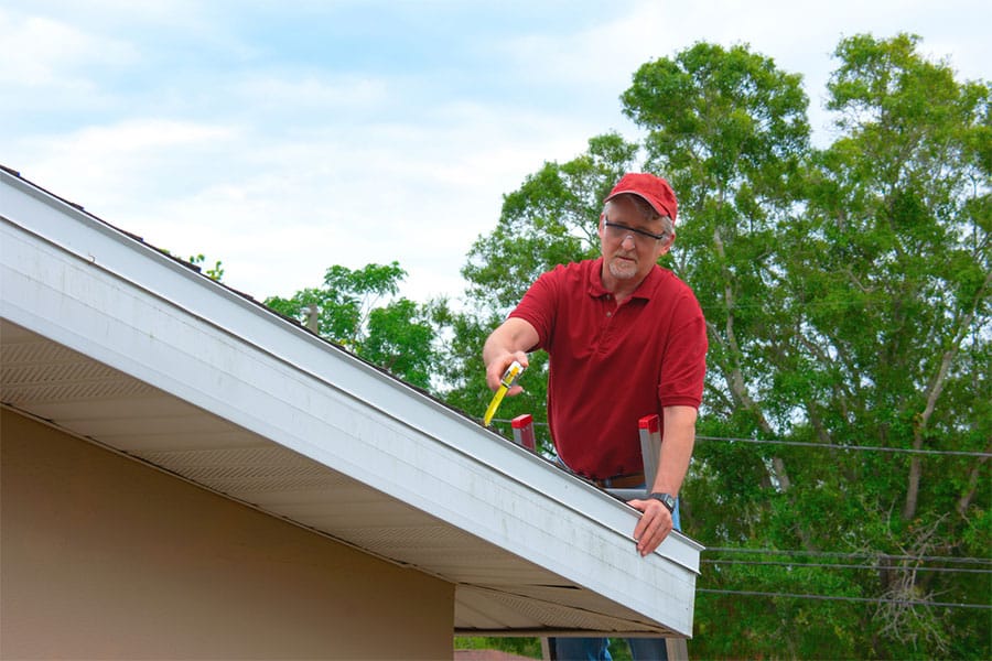 Roofer Inspecting Home's Roof